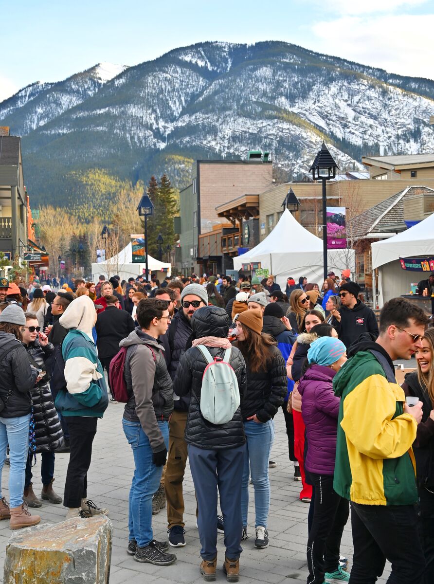 People mill about at the Bear Street outdoor festival during Made with Love - Banff Food & Cocktail Festival